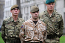 British soldiers model the new MTP (left and right) and existing desert kit (centre). Credit: British Army