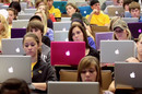 Students using MacBooks in a lecture hall
