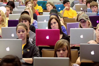 Students using MacBooks in a lecture hall