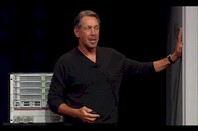 Larry Ellison lovingly pats his first Oracle mainframe
