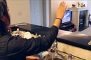 A hand gesture changes the TV channel using WiSee technology.
