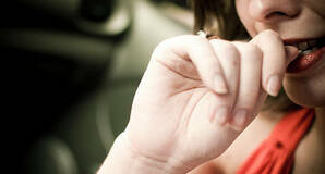 Nervous girl bites nails