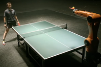 Timo Boll faces the Agilus robot at ping pong. Credit: KUKA