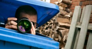 Spy hides in dustbin, lifts lid to take photograph