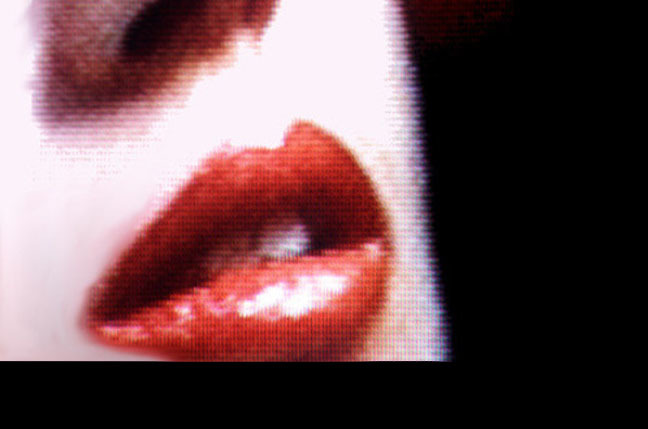 Close-up of a woman's lips, slightly pixelated as if on a CRT TV. http://www.sxc.hu/photo/20984  Pic via SXC - no restrictions