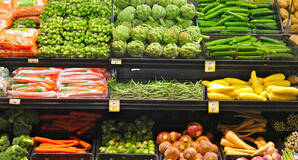 Fruit and vegetables on display on the shelves of a supermarket
