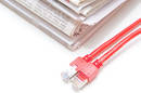 stack of newspapers with a pair of ethernet cables next to them