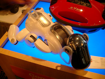 Sony's robotic Aibo dog near a robotic vacuum