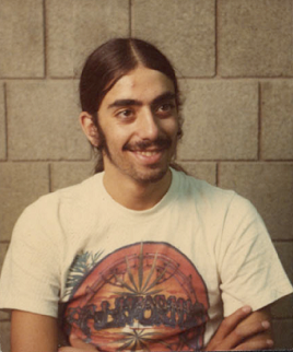 Daniel Klein as young man with ponytail tied back wearing teeshirt with marijuana motif