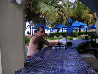 Shot of Hansen drinking on the job at poolside bar