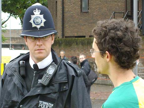 A policeman talks to an open source campaigner at the iplayer protest
