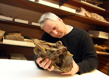 PhD student Mike Taylor and his fossil friend. Credit: NHM