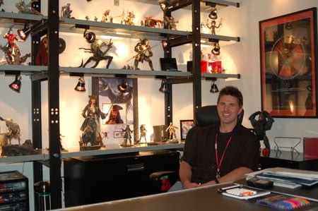 Shot of Rob Roy in his office, which is filled with cartoon and movie character action figures 