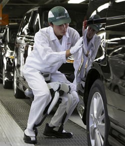 A Honda car worker tries out the walkermech