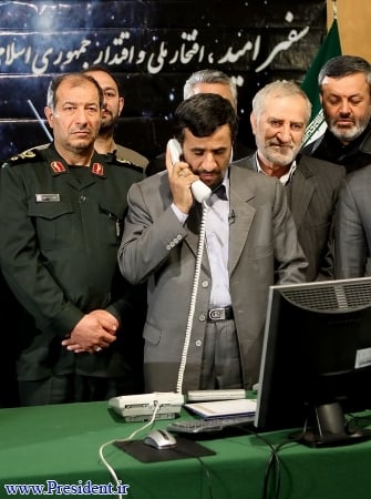 Iranian President Mahmoud Ahmadinejad receives news of the successful 'Omid' launch
