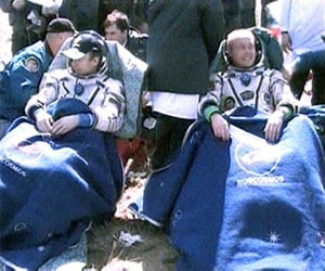 Expedition 18 Flight Engineer Yury Lonchakov (left) and Commander Mike Fincke relax outside the Soyuz TMA-13 capsule after landing in Kazakhstan. Pic: NASA