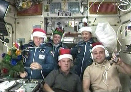 The Expedition 22 crew pose in festive hats. Pic: NASA