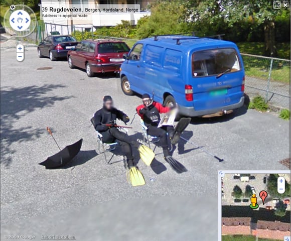 Two men dressed as frogmen sitting on Bergen street