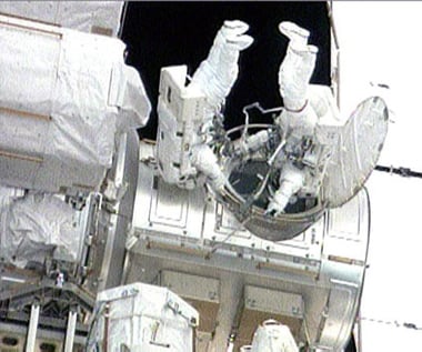 Steve Bowen (right) and Garrett Reisman exit the ISS. Pic: NASA TV