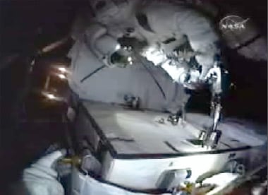 Spacewalker bolts battery to Integrated Cargo Carrier. Pic: NASA TV