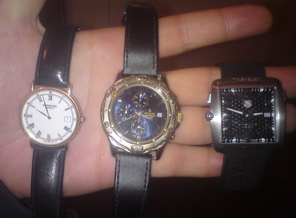 Photograph of Taylor holding the watches