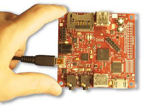 hand holding Beagleboard between two fingers