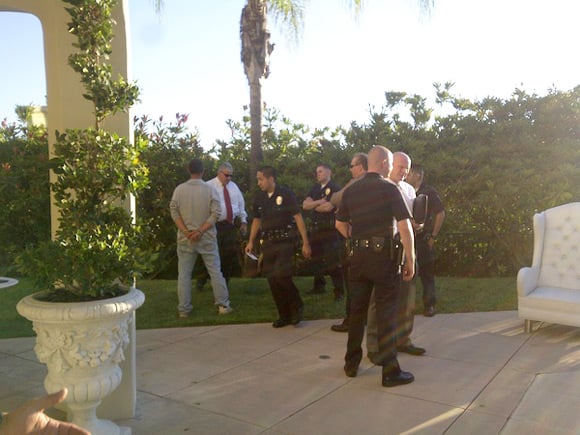 Photo of police and cuffed intruder at Paris Hilton's home