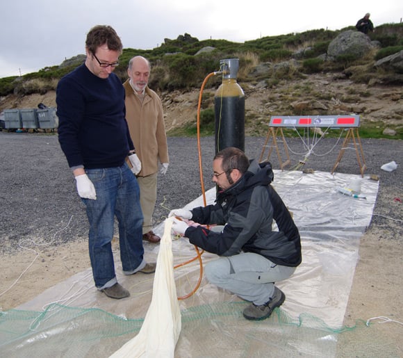 Federico, John and Jose Manuel attach the helium fill tube to the balloon