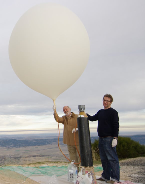 John and Jose Manuel happily filling the balloon