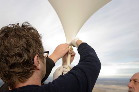 John ties off the balloon nozzle