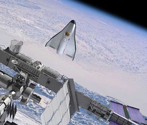 The proposed CCDev spaceplane from Orbital Sciences pictured during ISS operations. Credit: OSC