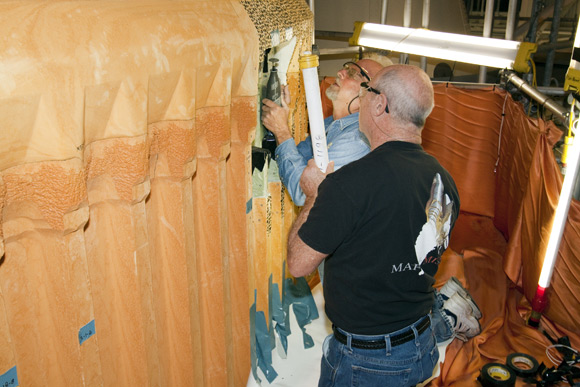 Engineers repairing Discovery's external fuel tank. Pic: NASA