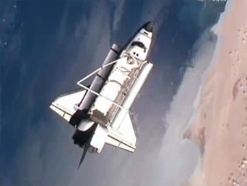 Discovery performs its flyaround of the International Space Station as both spacecraft orbit over the Sahara Desert. Pic: NASA TV 