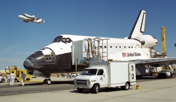 Shuttle Columbia, atop the Shuttle Carrier Aircraft, flys past Endeavour at Kennedy Space Center in 1994. Pic: NASA