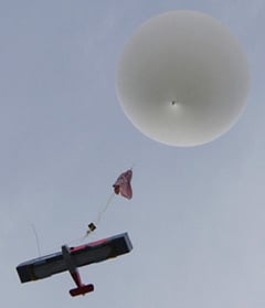 The Vulture 1 soars heavenwards under the helium balloon