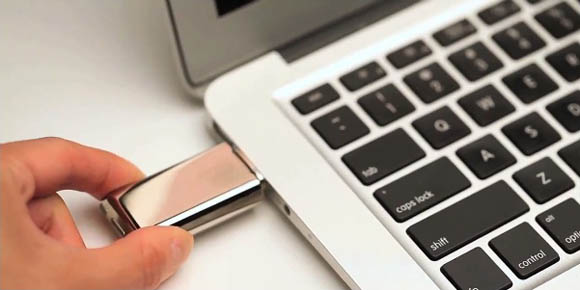 Crave's Duet USB flash drive and vibrator recharging in a MacBook Air