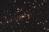 Hubble photo showing gravitational lensing warping the appearance of the galaxy cluster MACS J1206.2-0847