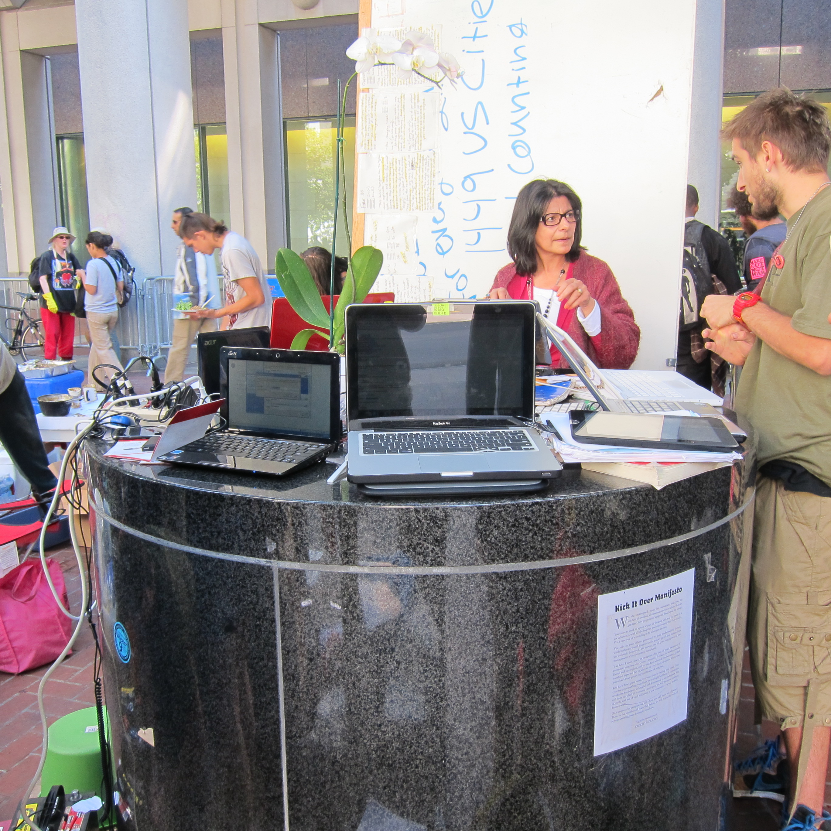 OccupySF are using a street bollard for a media center