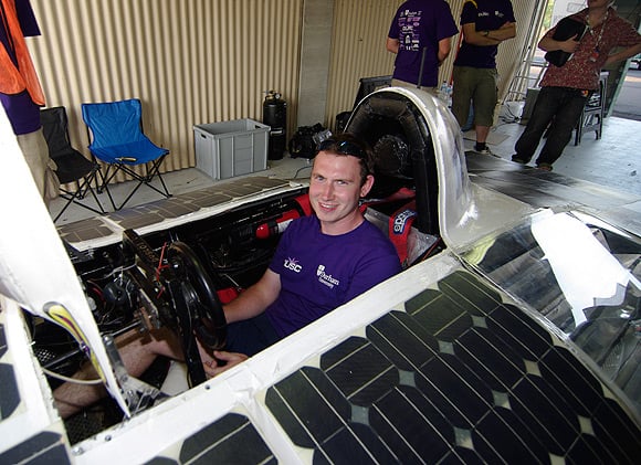 Durham Uni team member poses with his mighty vehicle