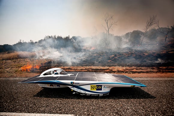 Nuon's Nuna6 drives by a bush fire: Pic: Nuon