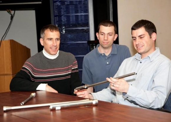 Picatinny engineer Vinny Leto (right) holds one of the cobalt alloy barrels produced using the flow forming technique. Credit: US Army