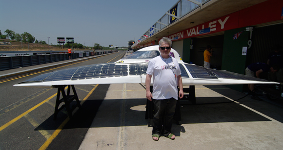 Drew Cullen poses with a solar car
