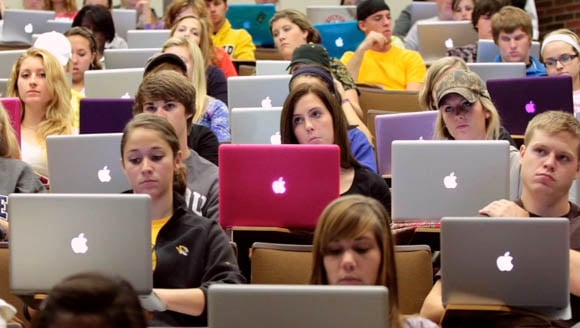 Students using MacBooks in a lecture hall