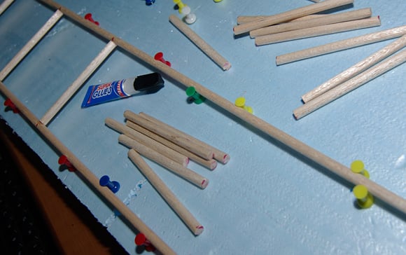 Balsa wood dowels coming together in our assembly jig