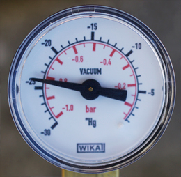 The vacuum gauge indicating 0.15 bar pressure