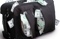Suitcase bulging with cash