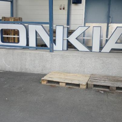 Nokia sign dismantled, with letters rearranged to spell 'ONKIA'