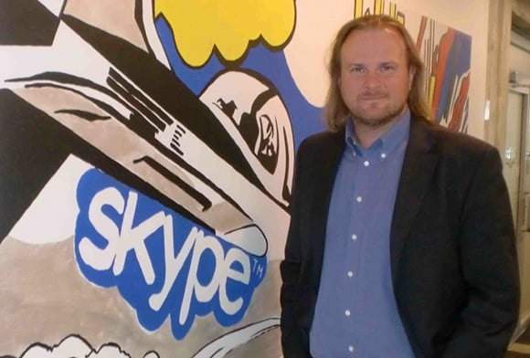 Tiit Paananen, boss of Skype Development labs, in front of Skype mural in the Estonia head office