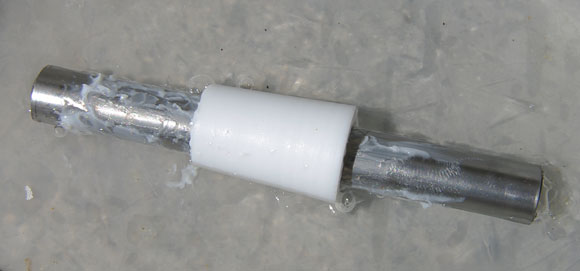 The Teflon insert and the rod half encased in ice