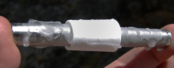 The frozen Teflon insert and tube, showing ice droplets